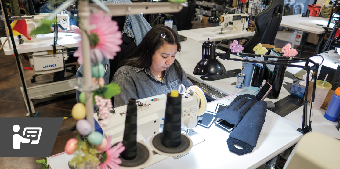 woman operating sewing machine